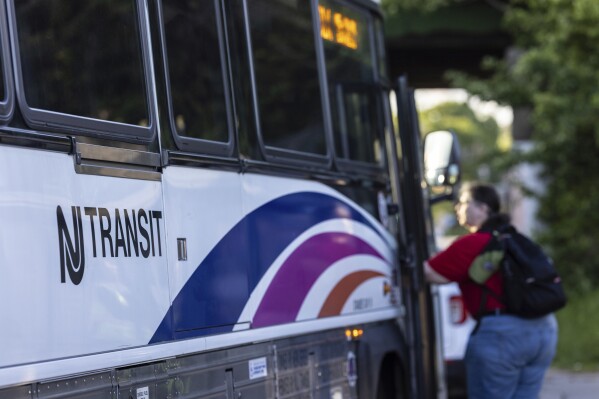 A commuter boards a NJ Transit bus bound for New York City at the Allwood Park and Ride stop in Clifton, N.J. on May 19, 2025. (AP Photo/Stefan Jeremiah, file)