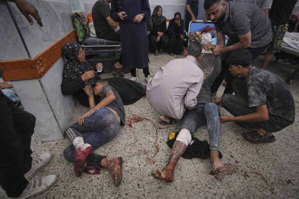 Palestinians are brought to Shifa Hospital after being wounded while on their way to an aid distribution center, in Gaza City, Thursday, July 3, 2025. (AP Photo/Jehad Alshrafi)