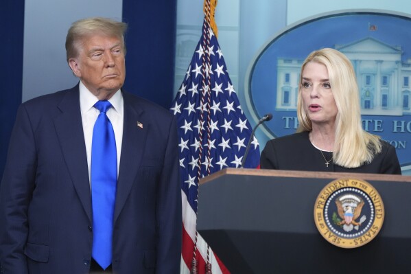 Attorney General Pam Bondi speaks to reporters as President Donald Trump listens, Friday, June 27, 2025, in the briefing room of the White House in Washington. (AP Photo/Jacquelyn Martin)