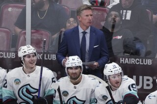 Seattle Kraken coach Dave Hakstol watches during the third period of the team's NHL hockey game against the Florida Panthers on Saturday, Oct. 28, 2023, in Sunrise, Fla. (AP Photo/Jim Rassol,File)