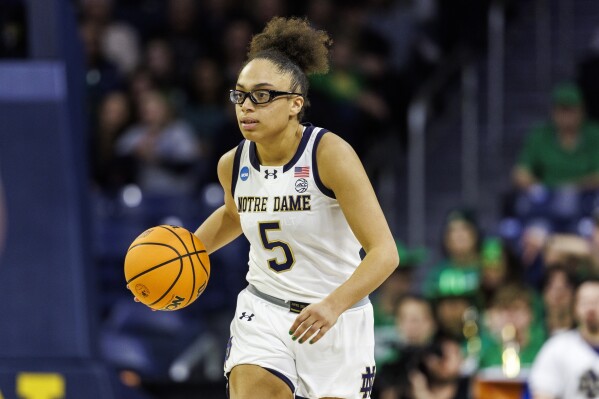 Notre Dame guard Olivia Miles (5) advances the ball during the second half in the first round of the NCAA college basketball tournament against Stephen F. Austin, March 21, 2025, in South Bend, Ind. (AP Photo/John Mersits, File)