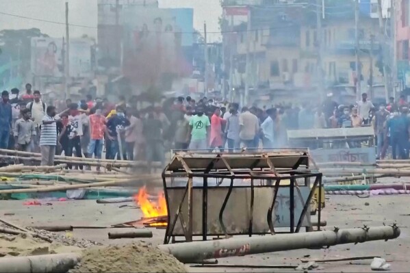 In this image made from a video, supporters of the ousted Prime Minister Sheikh Hasina clash with the police in Gopalganj, Bangladesh, Wednesday, July 16, 2025. (AP Photo)