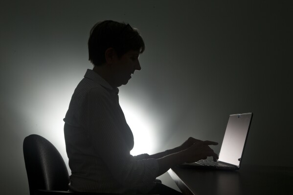 In this, Monday, Dec. 12, 2016, photo a woman types on her laptop, in Miami. (AP Photo/Wilfredo Lee, File)
