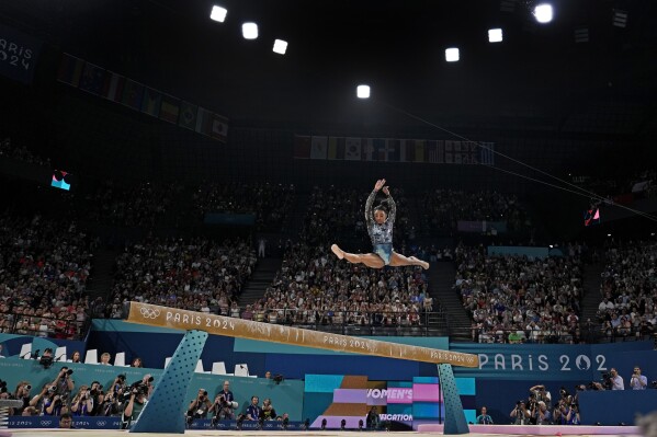 Simone Biles of the United States competes on the balance beam during a women's artistic gymnastics qualification round at the 2024 Summer Olympics, Sunday, July 28, 2024, in Paris, France. (AP Photo/Charlie Riedel)