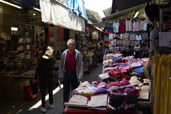 Shoppers move through a market in the Chinatown neighborhood of Los Angeles, Monday, April 21, 2025. (AP Photo/Andy Bao)
