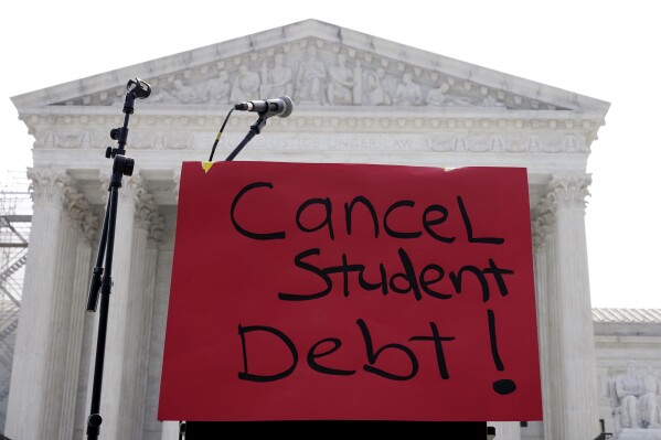 A sign reading "cancel student debt" is seen outside the Supreme Court, June 30, 2023, in Washington. (AP Photo/Mariam Zuhaib, File)