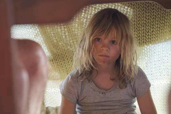 This image released by Sony Pictures Classics shows Lexi Venter in a scene from "Don’t Let’s Go to the Dogs Tonight." (Coco Van Oppens/Sony Pictures Classics via AP)