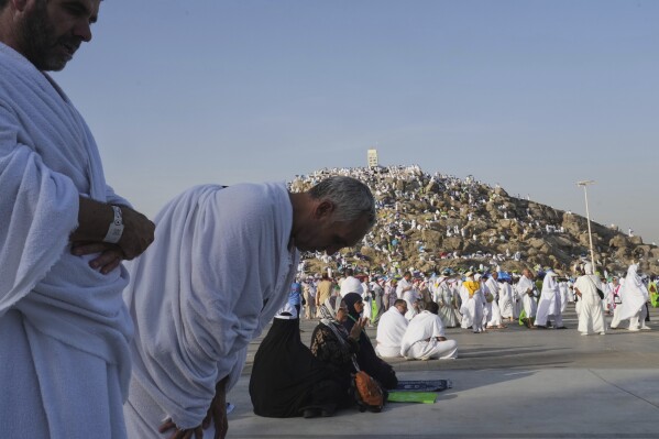 Muslim pilgrims offer prayers at top of the rocky hill known as the Mountain of Mercy, on the Plain of Arafat, during the annual Hajj pilgrimage near the holy city of Mecca, Saudi Arabia, Thursday, June 5, 2025. (AP Photo/Amr Nabil)
