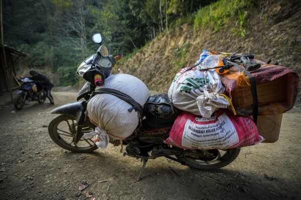 A motorcycle of a villager from Myanmar laded with goods is parked at the corner of a dirt road at Longwa village, in the India-Myanmar border in the far eastern state of Nagaland, Thursday, Dec.12, 2024. (AP Photo/Anupam Nath)