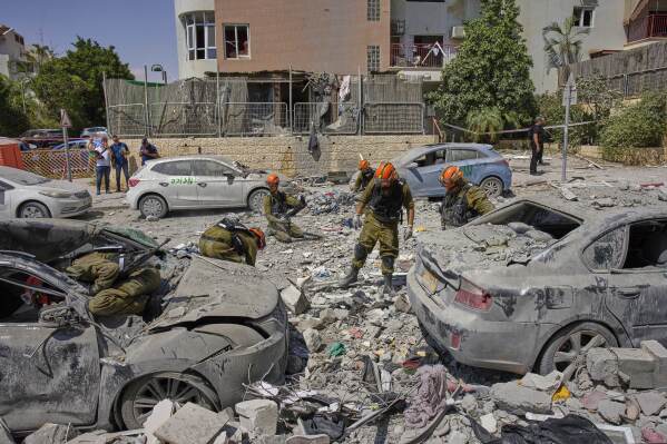 Israeli soldiers work amid the rubble of residential buildings destroyed by an Iranian missile strike that killed several people, in Beersheba, Israel, on Tuesday, June 24, 2025. (AP Photo/Bernat Armangue)