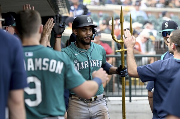 Seattle Mariners Julio Rodríguez (44) celebrates in the dugout after hitting a solo home run against the Detroit Tigers in the sixth inning of a baseball game, Saturday, July 12, 2025, in Detroit. (AP Photo/Lon Horwedel)