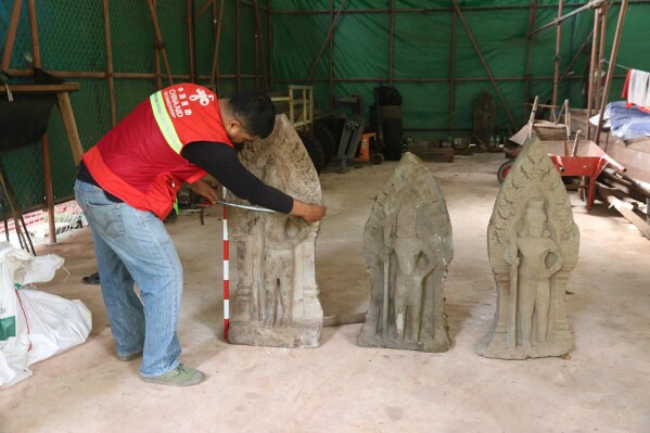This handout photo provided by Apsaras National Authority shows a centuries-old sandstone statue being measured at Angkor Thom in Cambodia, Oct. 24, 2024. (Phouk Chea/Apsaras National Authority via AP)