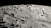 This image provided by NASA shows a view from orbit looking obliquely across the surface of the moon, where an ancient asteroid strike carved out a pair of grand canyons on the moon’s far side. (Ernie T. Wright/NASA via AP)