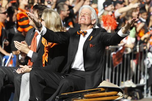 San Francisco Giants owner Bill Neukom celebrates while riding in a car during a baseball World Series parade in downtown San Francisco, Nov. 3, 2010. (AP Photo/Paul Sakuma, File)