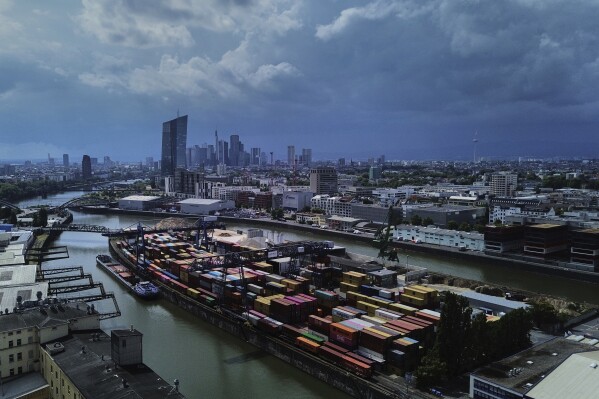 Containers are piled up at a cargo terminal in Frankfurt, Germany, Monday, July 14, 2025. (AP Photo/Michael Probst)