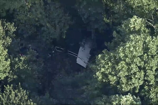 This image taken from video provided by WPVI-TV/6ABC shows a small skydiving aircraft that went off the end of a runway at Cross Keys Airport in Gloucester County, N.J., on Wednesday evening, July 2, 2025. (WPVI-TV/6ABC via AP)